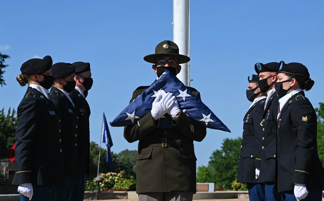 A U.S. Army drill sergeant folds the United States flag after Advanced Individual Training Soldiers lowered and folded it during the Memorial Day retreat ceremony at Joint Base Langley-Eustis, Virginia, May 27, 2021. On Memorial Day, the flag should be flown at half-staff from sunrise to noon and then raised to honor our Nations fallen heroes. (U.S. Air Force photo by Senior Airman Sarah Dowe)