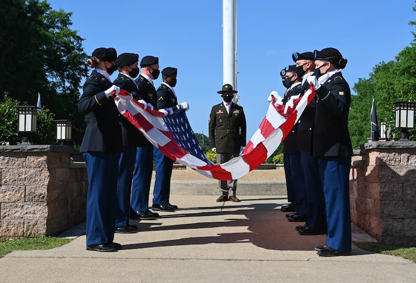 U.S. Army Advanced Individual Training Soldiers fold the United States Flag during the Memorial Day retreat ceremony at Joint Base Langley-Eustis, Virginia, May 27, 2021. Each of the 13 folds of the flag has a special meaning. (U.S. Air Force photo by Senior Airman Sarah Dowe)