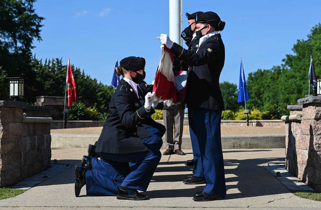 U.S. Army Advanced Individual Training Soldiers fold the United States Flag during the Memorial Day retreat ceremony at Joint Base Langley-Eustis, Virginia, May 27, 2021. Each of the 13 folds of the flag has a special meaning. (U.S. Air Force photo by Senior Airman Sarah Dowe)
