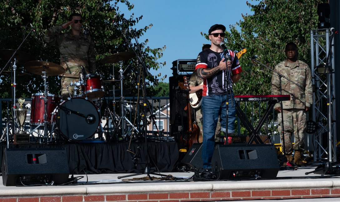 J.P. Lane sings the Star Spangled Banner to kick off the Austin Moody concert at Joint Base Langley-Eustis, Virginia, May 27, 2021. Lane, a veteran and Purple Heart recipient, is now a motivational speaker and musician. (U.S. Air Force photo by Staff Sgt. Chandler Baker)