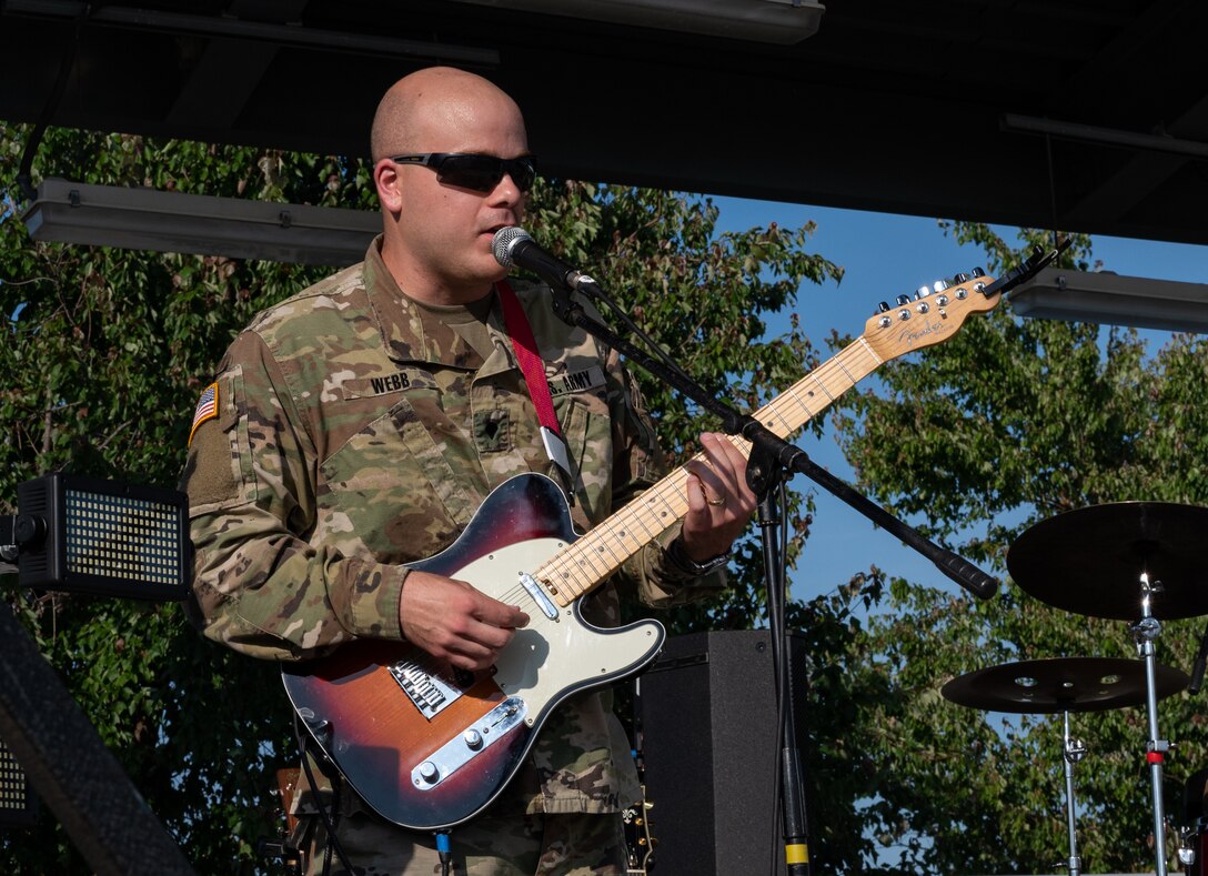U.S. Army Spc. Colin Webb, U.S. Army Training and Doctrine Command Band lead guitar, plays with the band “High Tide” during the Austin Moody concert at Joint Base Langley-Eustis, Virginia, May 27, 2021. The TRADOC band opened for Moody. (U.S. Air Force photo by Staff Sgt. Chandler Baker)