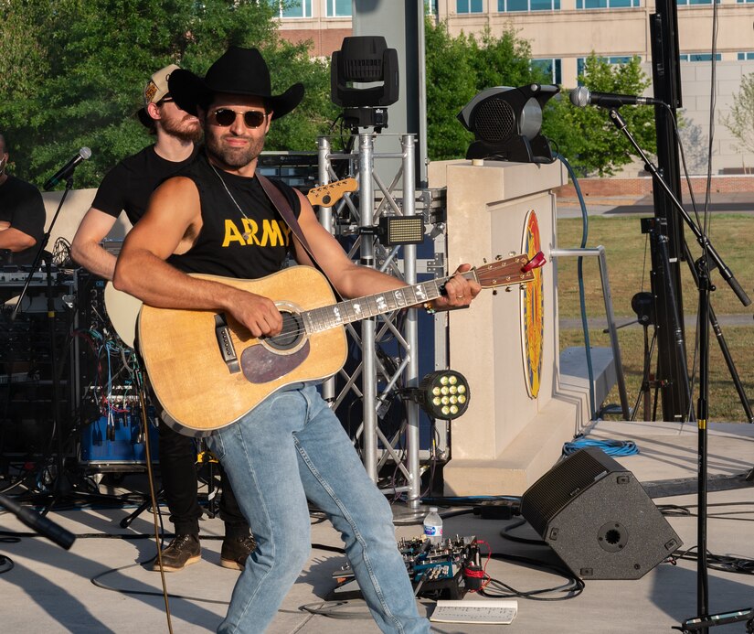 Austin Moody plays his acoustic guitar during a concert at Joint Base Langley-Eustis, Virginia, May 27, 2021. Moody performed at Eustis to give back to the service members and their families for their sacrifices. (U.S. Air Force photo by Staff Sgt. Chandler Baker)