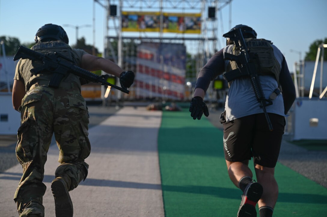 Two U.S. Soldiers take off at a sprint during the Military Battle Challenge obstacle course at Joint Base Langley-Eustis, Virginia, May 22, 2021. The Military Battle Challenge is a timed obstacle course that tests Soldiers' abilities over nine separate tasks. (U.S. Air Force photo by Senior Airman John Foister)