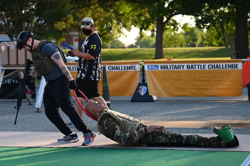 A U.S. Soldier drags a 200 pound man-down rescue dummy during the Military Battle Challenge obstacle course at Joint Base Langley-Eustis, Virginia, May 22, 2021. The Military Battle Challenge is a timed obstacle course that tests Soldiers' abilities over nine separate tasks. (U.S. Air Force photo by Senior Airman John Foister)