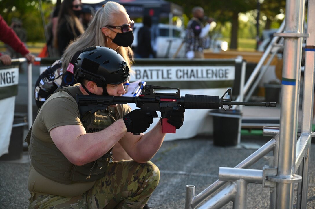 A U.S. Soldier takes aim with a laser-equipped practice rifle during the Military Battle Challenge obstacle course at Joint Base Langley-Eustis, Virginia, May 22, 2021. The Military Battle Challenge is a timed obstacle course that tests Soldiers' abilities over nine separate tasks. (U.S. Air Force photo by Senior Airman John Foister)