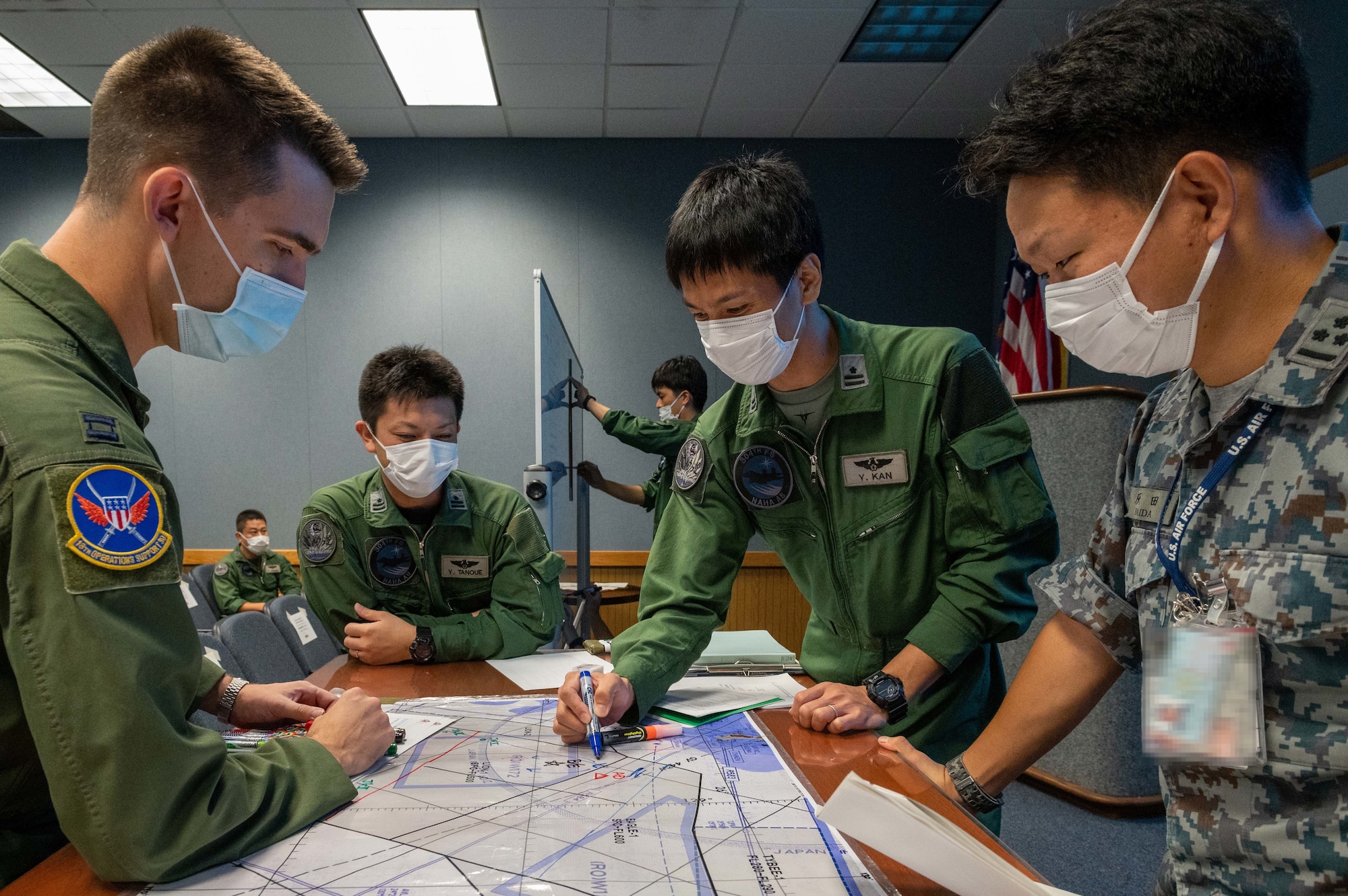 U.S. Air Force Capt. Robert Banicki, 18th Operations Support Squadron bilateral liaison, and Japan Air Self-Defense Force members mission plan during Exercise Southern Beach at Kadena Air Base, Japan, Oct. 25, 2021. Exercise Southern Beach is a large-scale Japan-U.S. joint training effort. (U.S. Air Force photo by Airman 1st Class Yosselin Perla)