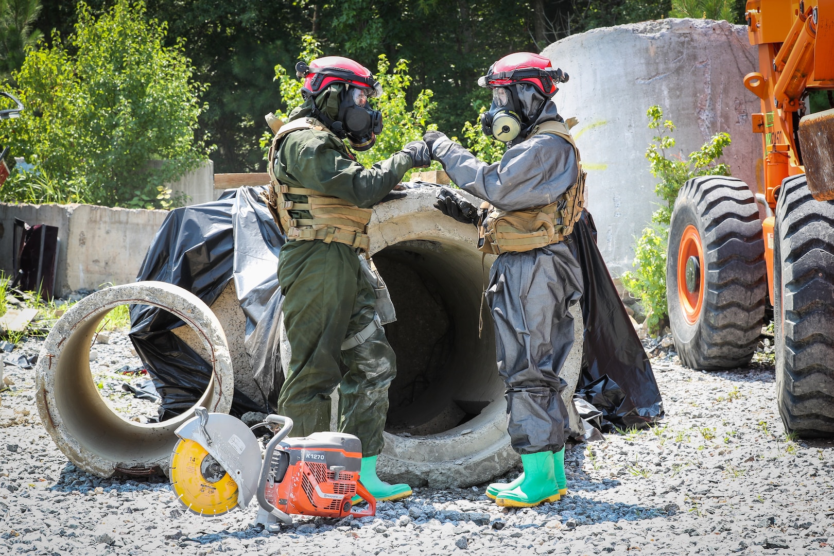 A Chemical Biological Incident Response Force (CBIRF) Marine tags out his teammate during a concrete breaching exercise while developmental equipment monitors air quality during the Technology Experimentation and Characterization Field Trials at the CBIRF Downey Responder Training Facility, July 26-30. The trials were cohosted by Naval Surface Warfare Center Indian Head Division Chemical, Biological and Radiological Defense Division and CBIRF. (U.S. Navy photo by Matthew Poynor)