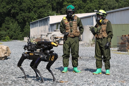 Chemical Biological Incident Response Force (CBIRF) Marines monitor the progress of an unmanned ground vehicle (UGV) "Cerberus" down range as the UGV searches for chemical and radiation hazards during the Technology Experimentation and Characterization Field Trials at the CBIRF Downey Responder Training Facility, July 26-30. The trials were cohosted by Naval Surface Warfare Center Indian Head Division Chemical, Biological and Radiological Defense Division and CBIRF. (U.S. Navy photo by Matthew Poynor)