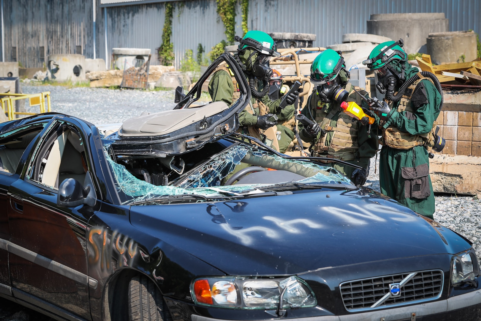Chemical Biological Incident Response Force (CBIRF) Marines look for radiation hazards in an abandoned car using developmental equipment and compare the readings against their own equipment during the Technology Experimentation and Characterization Field Trials at the CBIRF Downey Responder Training Facility, July 26-30. The trials were cohosted by Naval Surface Warfare Center Indian Head Division Chemical, Biological and Radiological Defense Division and CBIRF. (U.S. Navy photo by Matthew Poynor)