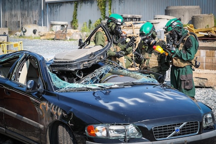 Chemical Biological Incident Response Force (CBIRF) Marines look for radiation hazards in an abandoned car using developmental equipment and compare the readings against their own equipment during the Technology Experimentation and Characterization Field Trials at the CBIRF Downey Responder Training Facility, July 26-30. The trials were cohosted by Naval Surface Warfare Center Indian Head Division Chemical, Biological and Radiological Defense Division and CBIRF. (U.S. Navy photo by Matthew Poynor)