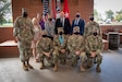 U.S. Army Soldiers posing with an award.