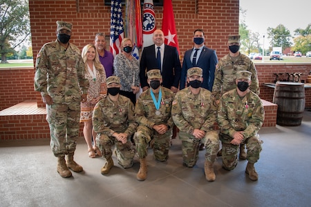 U.S. Army Soldiers posing with an award.