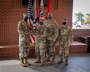 U.S. Army Soldiers posing with an award.