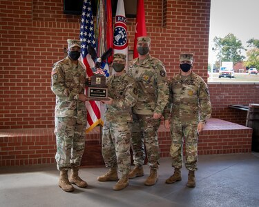 U.S. Army Soldiers posing with an award.