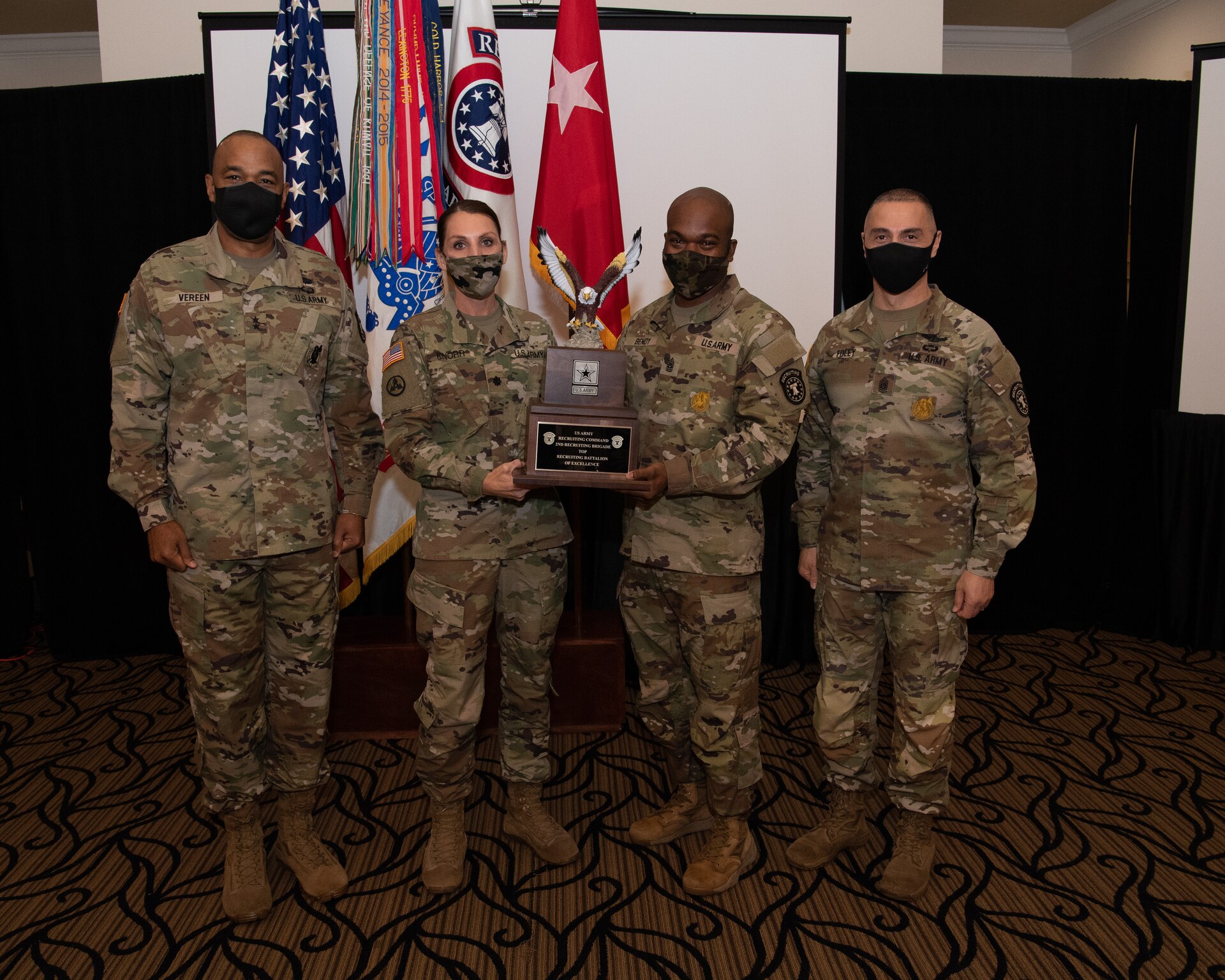 U.S. Army Soldiers posing with an award.