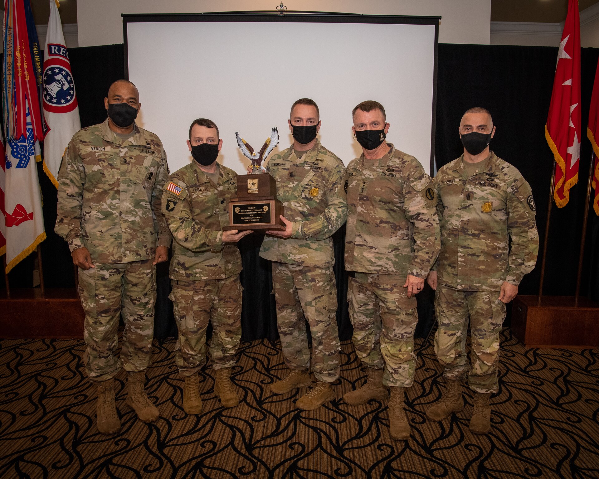 U.S. Army Soldiers posing with an award.
