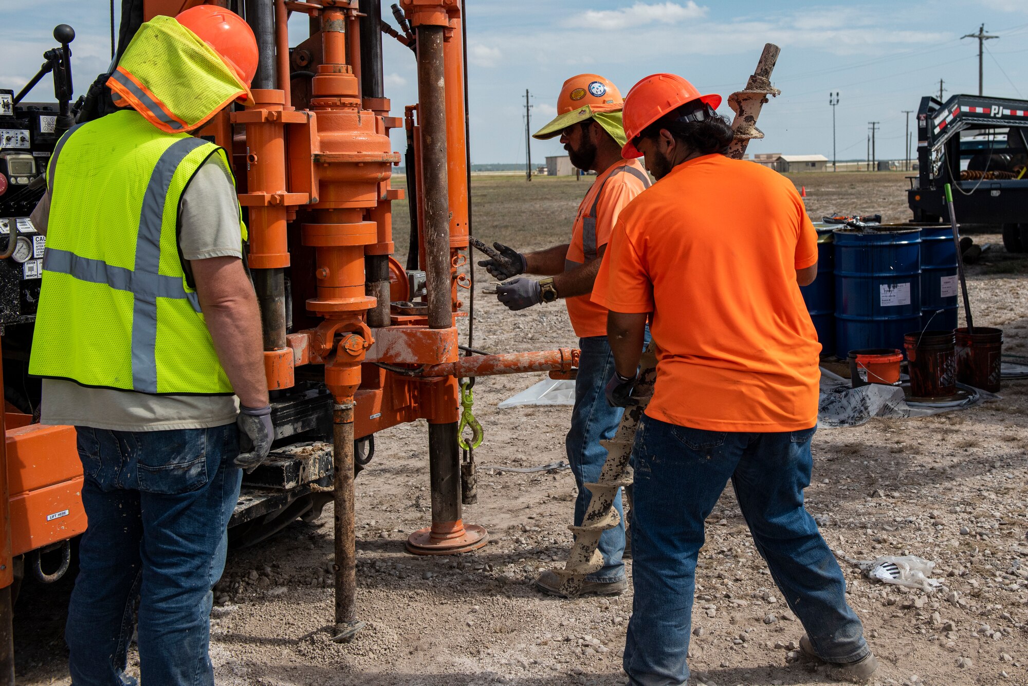 Working crews change the drill head of an industrial auger drill before moving to a new site to continue excavating the area to reduce the trichloroethylene in the area.  Trichloroethylene (TCE) is a volatile, colorless liquid organic chemical. TCE does not occur naturally and is created by chemical synthesis. It is used primarily to make refrigerants and other hydrofluorocarbons and as a degreasing solvent for metal equipment. (U.S. Air Force photo by Senior Airman David Phaff)