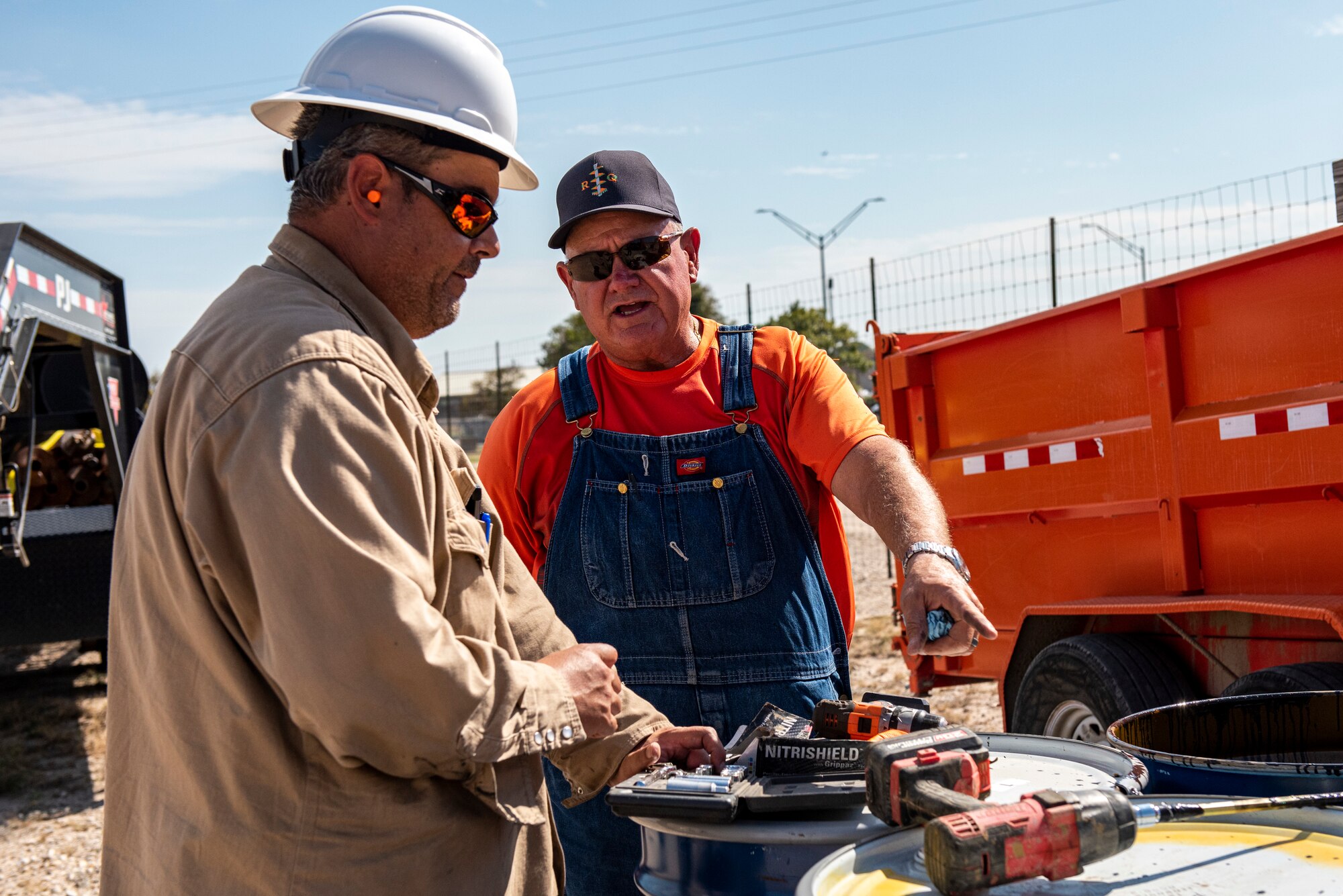 Site managers discuss the day's goals and expectations for the crews while going over long term expectations for the project. This process will take about five months before tests will show a reduction in contamination levels and continue to lower with more treatments. (U.S. Air Force photo by Senior Airman David Phaff)