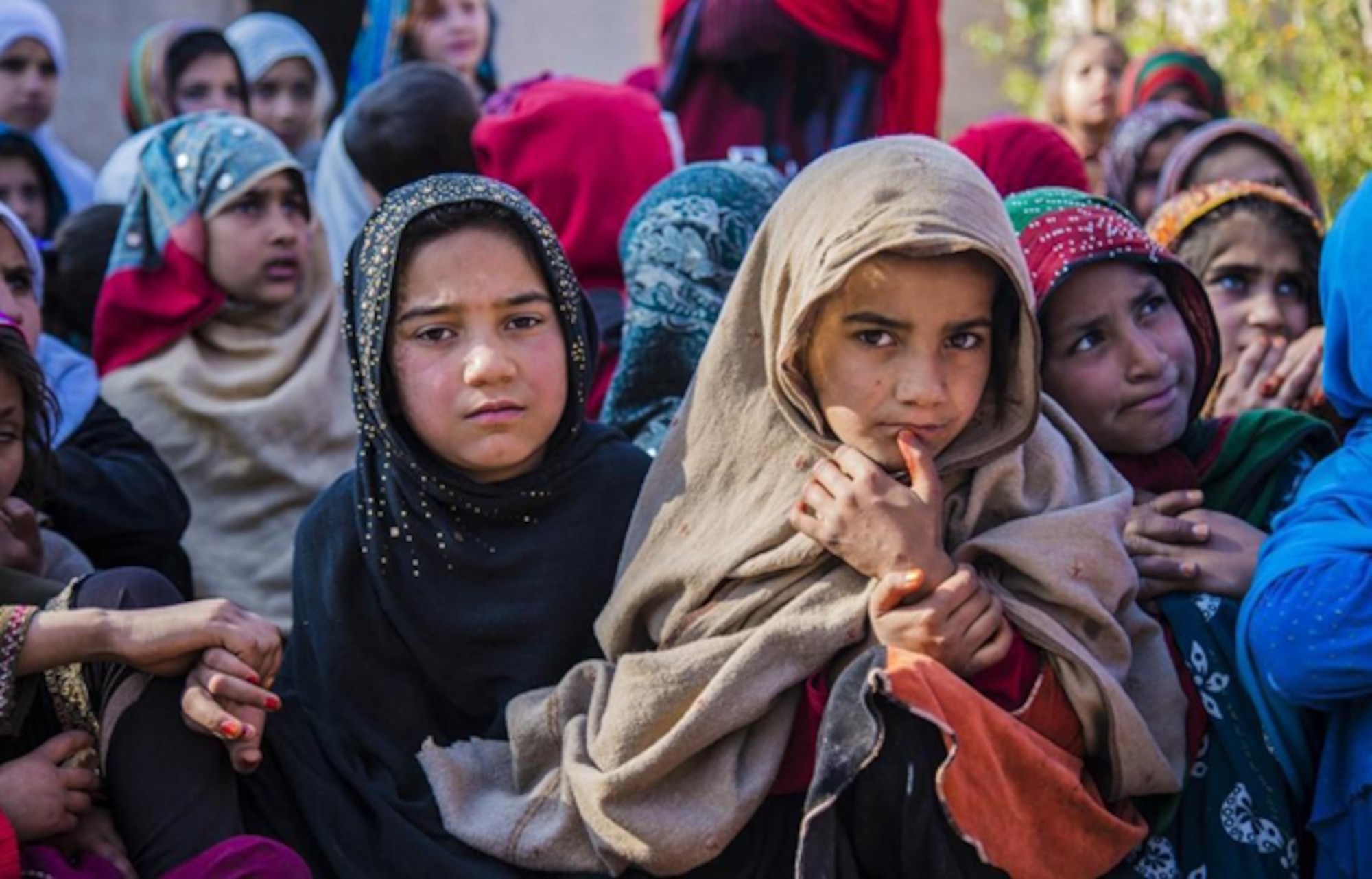 Afghani girls peer at the camera