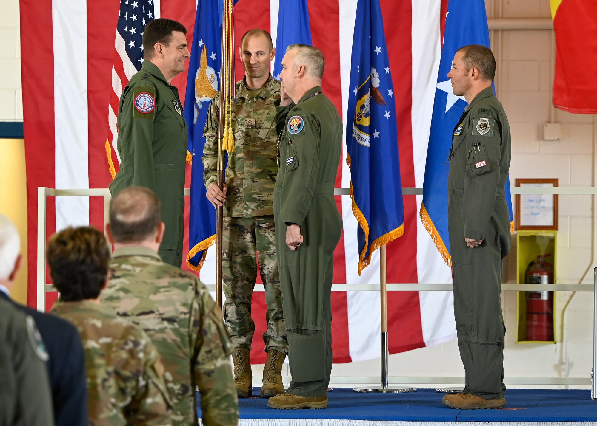 Col. Jeremiah S. tucker, right, salutes Lt. Gen. Michael A. Loh as he relinquishes command