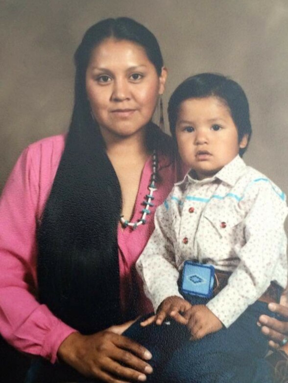 A young Sgt. 1st Class James R. Redner poses with his mother, Charlene, in a photo taken in his childhood. Redner, an Army watercraft engineer assigned to the 401st Army Field Support Brigade, 1st Theater Sustainment Command, is descended from the Nuumu (Paiute) and Newe (Shoshone) people in Bishop, Calif. My mom, she’s very traditional—she attends all the powwows, she makes all the regalia, she always tried getting us involved in the ceremonies, the sweat lodges, the powwows, just anything and everything,” he said. “Of course me, I took the Army route.” (Photo courtesy of Sgt. 1st Class James R. Redner)