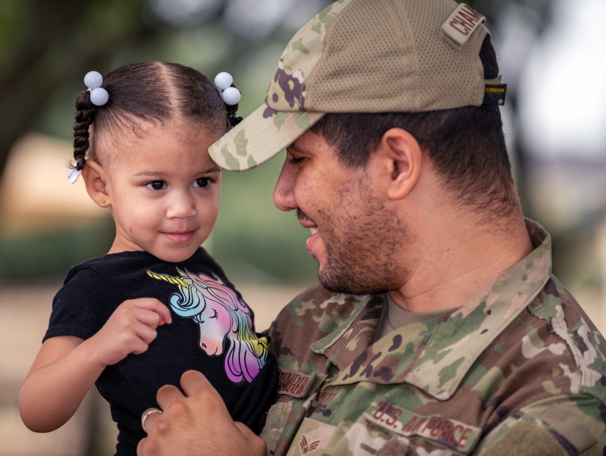 U.S. Air Force Senior Airman Brian Chambers, 502nd Contracting Squadron contract specialist, holds his daughter