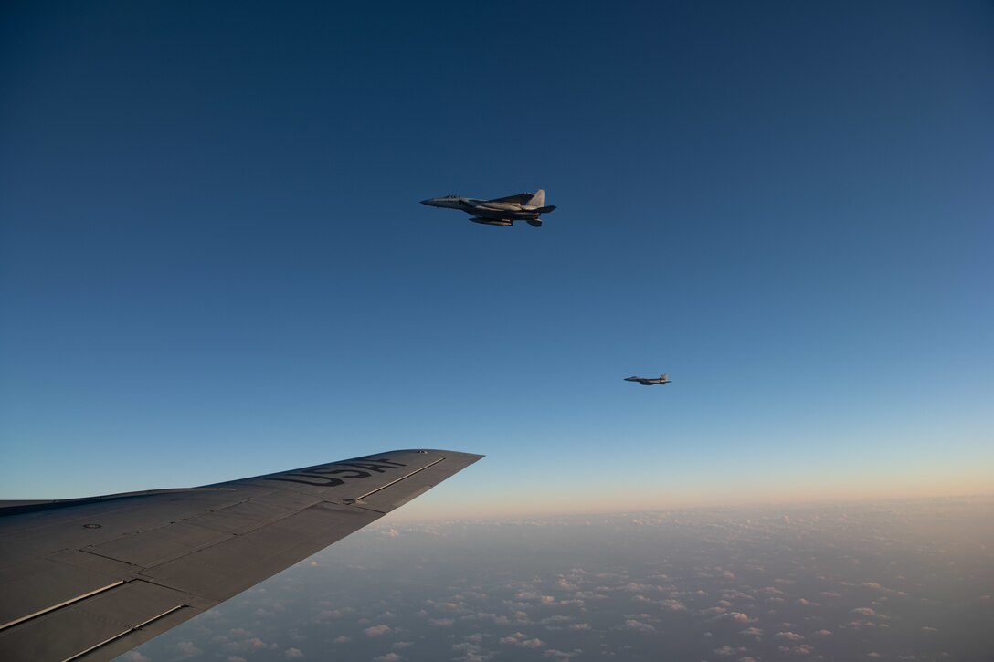 Two Japan Air Self-Defense Force F-15DJ Eagles fly next to a U.S. Air Force KC-135 Stratotanker from the 909th Air Refueling Squadron after refueling over the Pacific Ocean during Exercise Southern Beach, Oct. 28, 2021. The large force exercise primarily focused on offensive and defensive counter air operations, personnel rescue and airdrop missions.