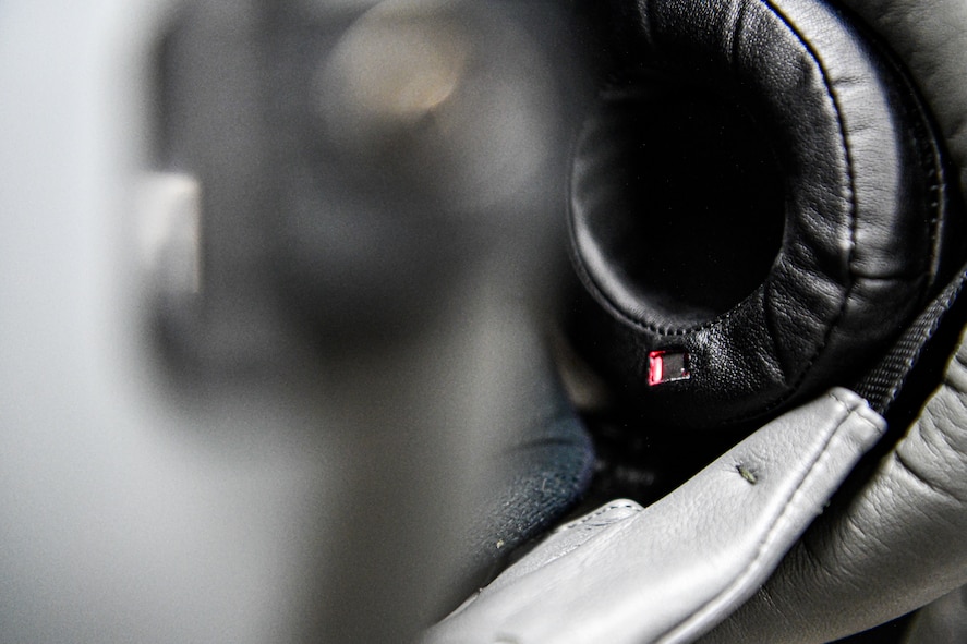 Lt. Col. Michael 'Shot' Glass shows the location of SPYDR in his helmet Oct. 28, 2021, at Barnes Air National Guard Base, Massachusetts. The SPYDR system provides an audible warning when a pilot's oxygen saturation drops below a specific threshold, enhancing their safety and tactical capabilities.(U.S. Air National Guard photo by Randy Burlingame)