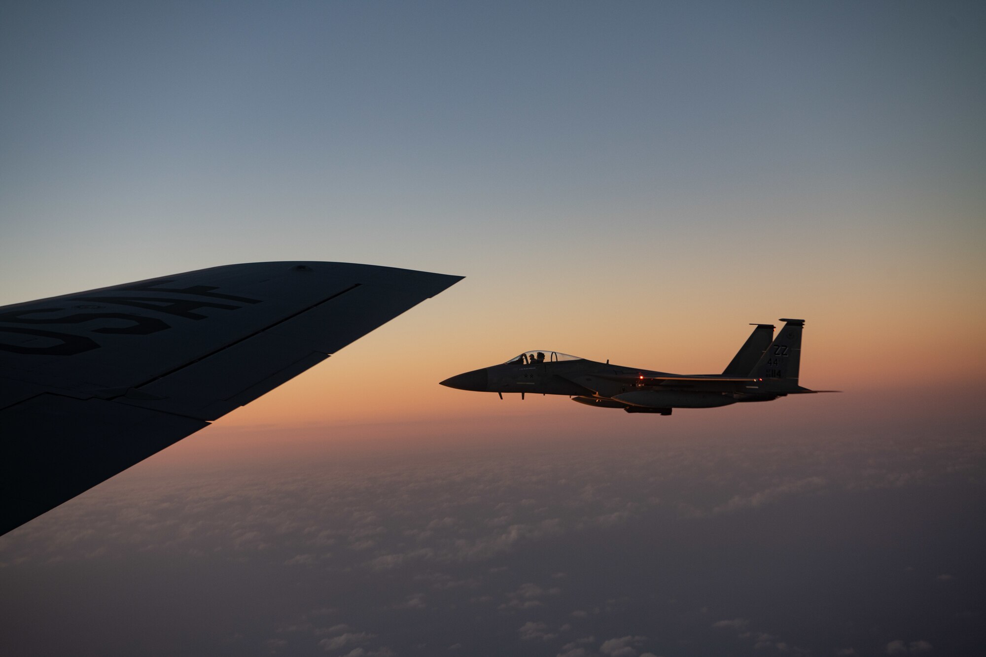 A U.S. Air Force F-15C Eagle flies next to a KC-135 Stratotanker from the 909th Air Refueling Squadron over the Pacific Ocean during Exercise Southern Beach, Oct. 28, 2021. This was the first time since the inception of Southern Beach in which the majority of the mission sets and a Japan-U.S. training program were conducted during night time hours. (U.S. Air Force photo by Staff Sgt. Savannah L. Waters)