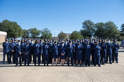 Airmen and officers gather for a group photo during the 2021 Community College of the Air Force graduation, Oct. 21, 2021, at Joint Base Andrews, Md.