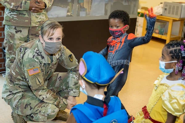Col. Paige M. Jennings, U.S. Army Financial Management Command commander, talks with costumed students at a local daycare facility next to the Maj. Gen. Emmett J. Bean Federal Center Oct. 29, 2021. Jennings, along with Barry W. Hoffman, USAFMCOM deputy to the commander, and Command Sgt. Maj. Kenneth F. Law, USAFMCOM senior enlisted advisor, delivered 100 festive treat bags to students at the center. (U.S. Army photo by Mark R. W. Orders-Woempner)