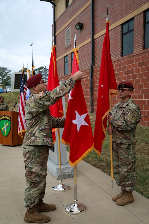 Sgt. 1st Class Alexander Duncan, noncommissioned officer in charge for the U.S. Army Civil Affairs and Psychological Operations Command (Airborne) Strategic Initiatives Group (SIG), inspects the new two-star flag for Maj. Gen. Jeffrey C. Coggin, commanding general, USACAPOC(A), during the promotion ceremony held Oct. 25, 2021, Fort Bragg, N.C.