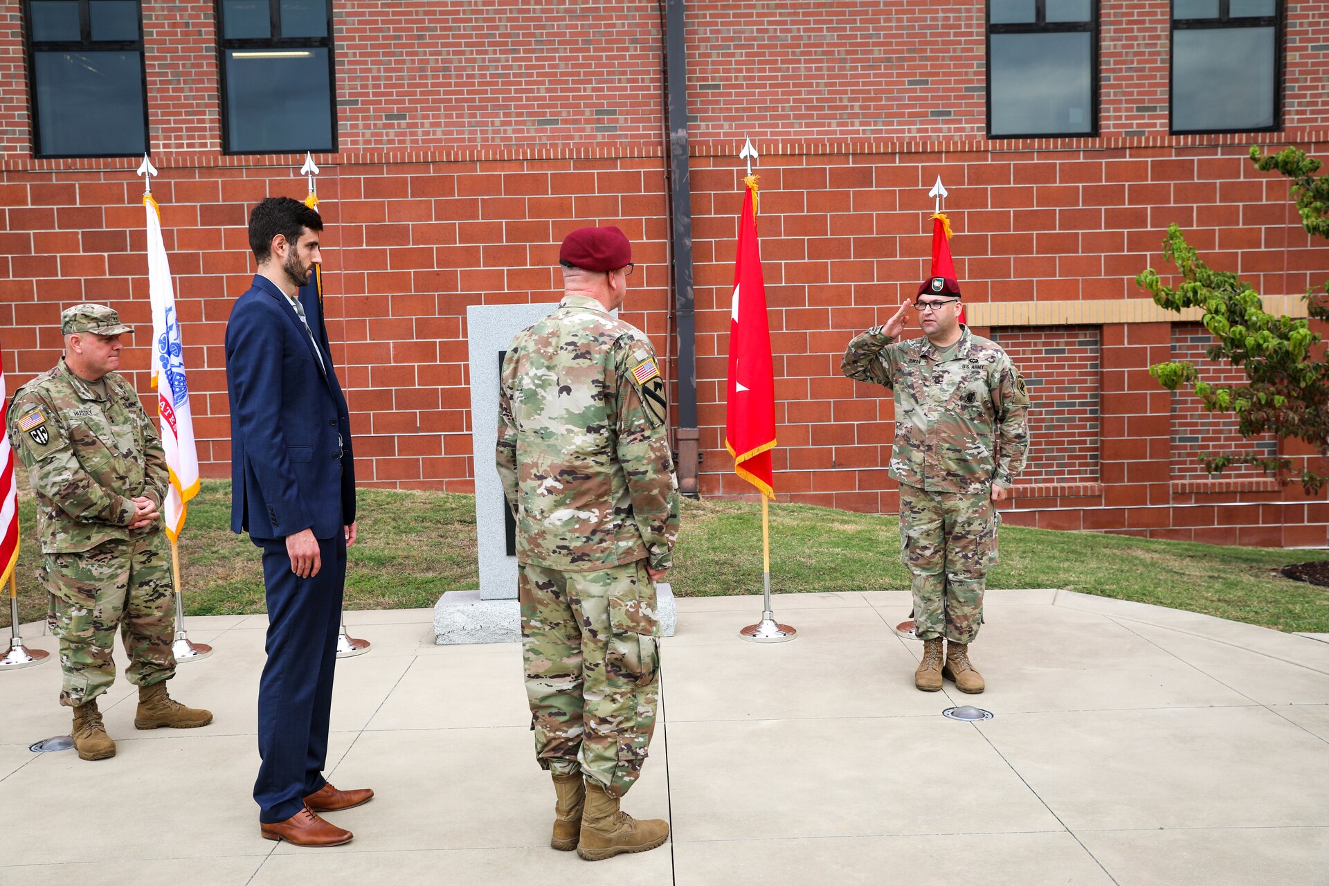 Sgt. 1st Class Alexander Duncan, noncommissioned officer in charge for the U.S. Army Civil Affairs and Psychological Operations Command (Airborne) Strategic Initiatives Group (SIG) (right), presents the newly posted two-star flag to Maj. Gen. Jeffrey C. Coggin, commanding general, USACAPOC(A), during Coggin’s promotion ceremony, Oct. 25, 2021, Fort Bragg, N.C.