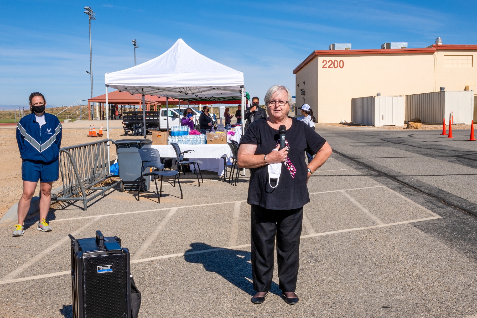 Lynn King, Health Benefits Advisor, TRICARE Operations and Patient Administration Flight, 412th Medical Group, talks about her experience as a two-time cancer survivor during the 5K Run/Walk and Mini Health Fair in support of Breast Cancer Awareness Month at the Rosburg Fitness Center on Edwards Air Force Base, California, Oct. 20. (Air Force photo by Katherine Franco)