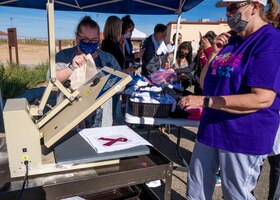 Airmen and civilians came out to the 5K Run/Walk and Mini Health Fair in support of Breast Cancer Awareness Month at the Rosburg Fitness Center on Edwards Air Force Base, California, Oct. 20. The first 50 participants received free T-shirts with the ubiquitous pink ribbon symbol for breast cancer. (Air Force photo by Katherine Franco)