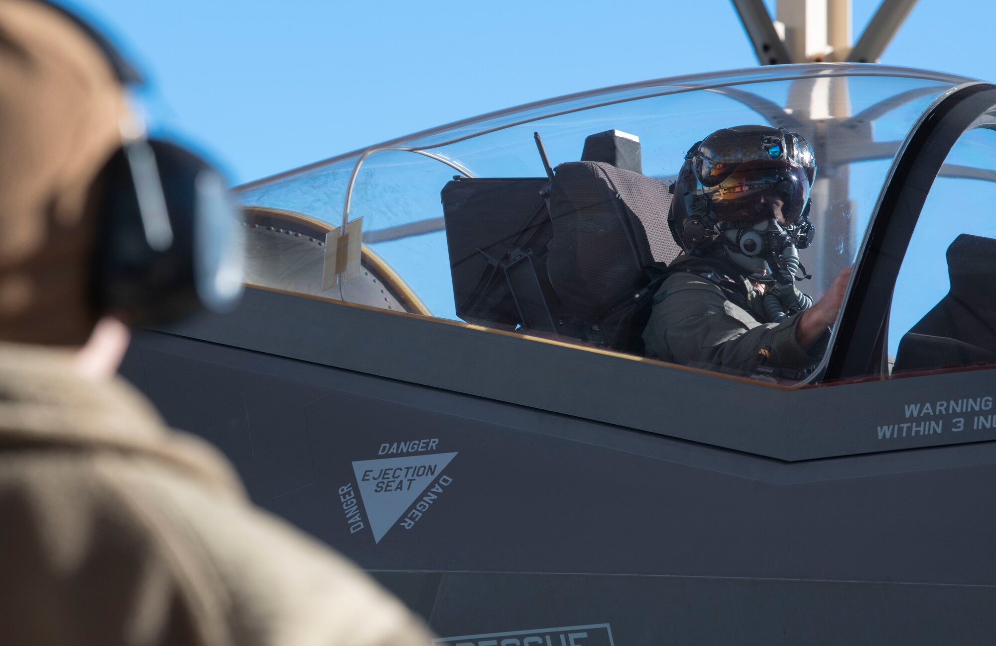 Maj. Daniel Prudhomme, Orange Flag director and F-35 Test Pilot assigned to the 461st Flight Test Squadron, awaits confirmation signals from his crew chief at Edwards Air Force Base, Calif., Oct. 26, 2021