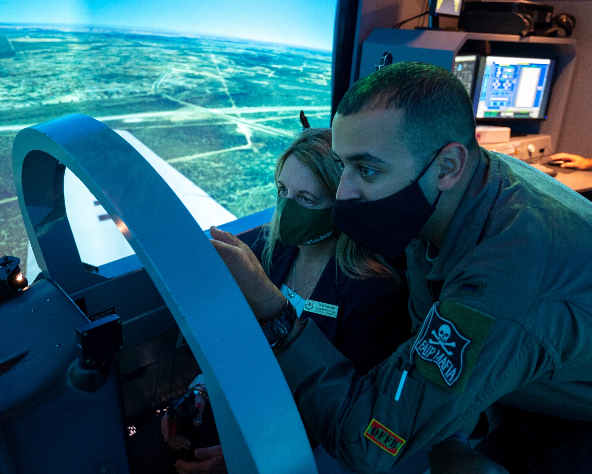 Debi Graham, Air Education and Training Command civic leader from Naval Air Station Pensacola, Florida, sits in a T-6 Texan II simulator during a civic leader tour at Laughlin Air Force Base, Texas, Oct. 28, 2021. The AETC Civic Leader Group visit allows for civic leaders to see an AETC base’s mission up close and learn more about how civilian leaders and military members can work together.  (U.S. Air Force photo by Senior Airman Nicholas Larsen)