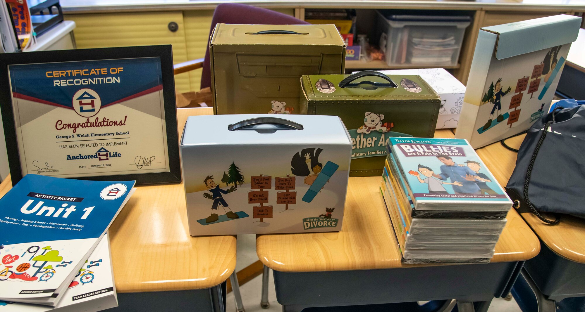 Resilience kits are displayed during a faculty training session Oct. 19, 2021, at Welch Elementary School on Dover Air Force Base, Delaware. The kits contain a variety of booklets, journals and DVDs that student team leads can share with peers who are going through difficult life transitions. (U.S. Air Force photo by Senior Airman Stephani Barge)