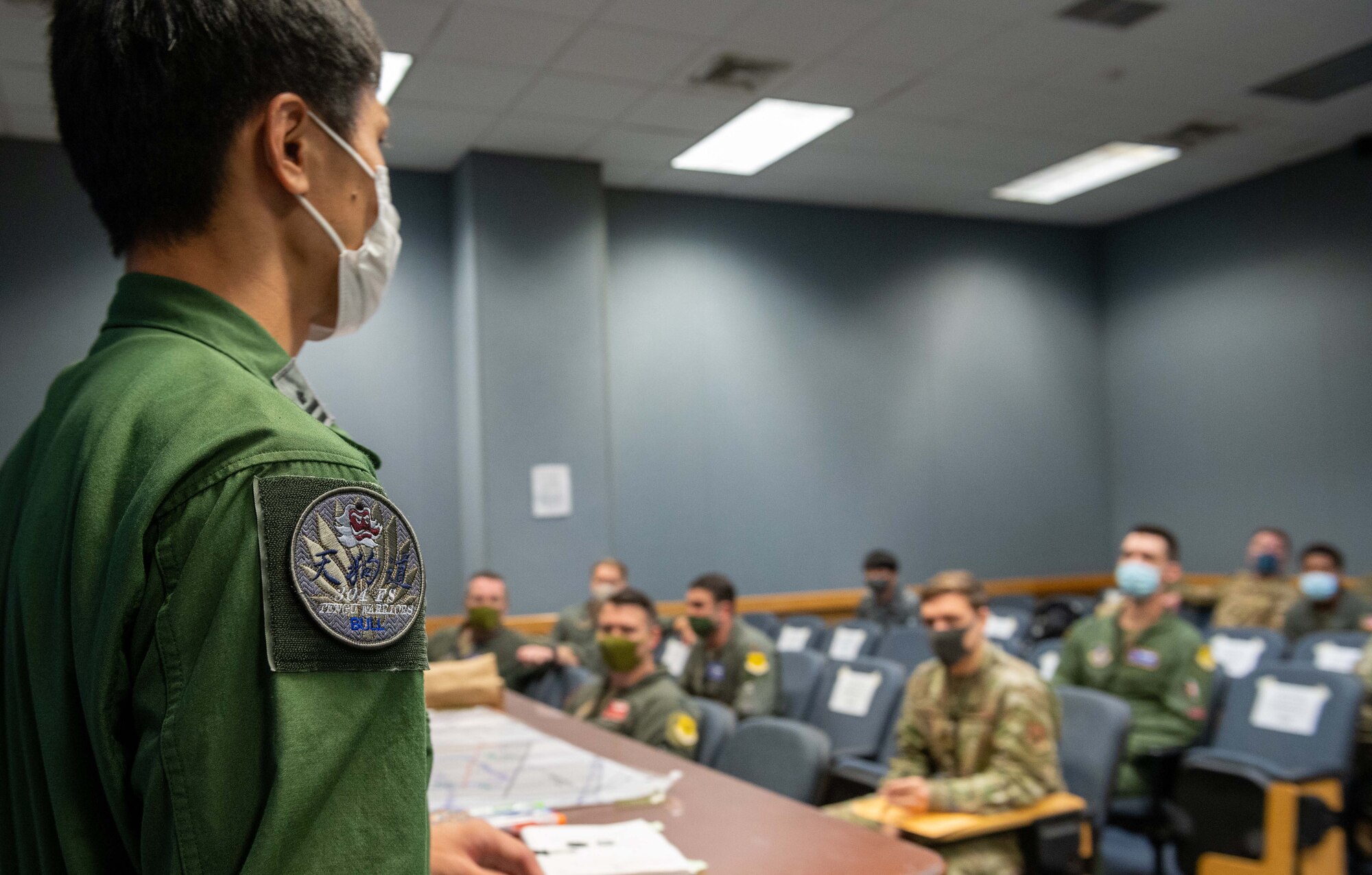 A Japan Air Self-Defense Force member briefs members of the 18th Wing during Exercise Southern Beach at Kadena Air Base, Japan, Oct. 25, 2021. The JASDF and USAF conduct training together to enhance bilateral response capabilities and improve tactical skills. (U.S. Air Force photo by Airman 1st Class Yosselin Perla)