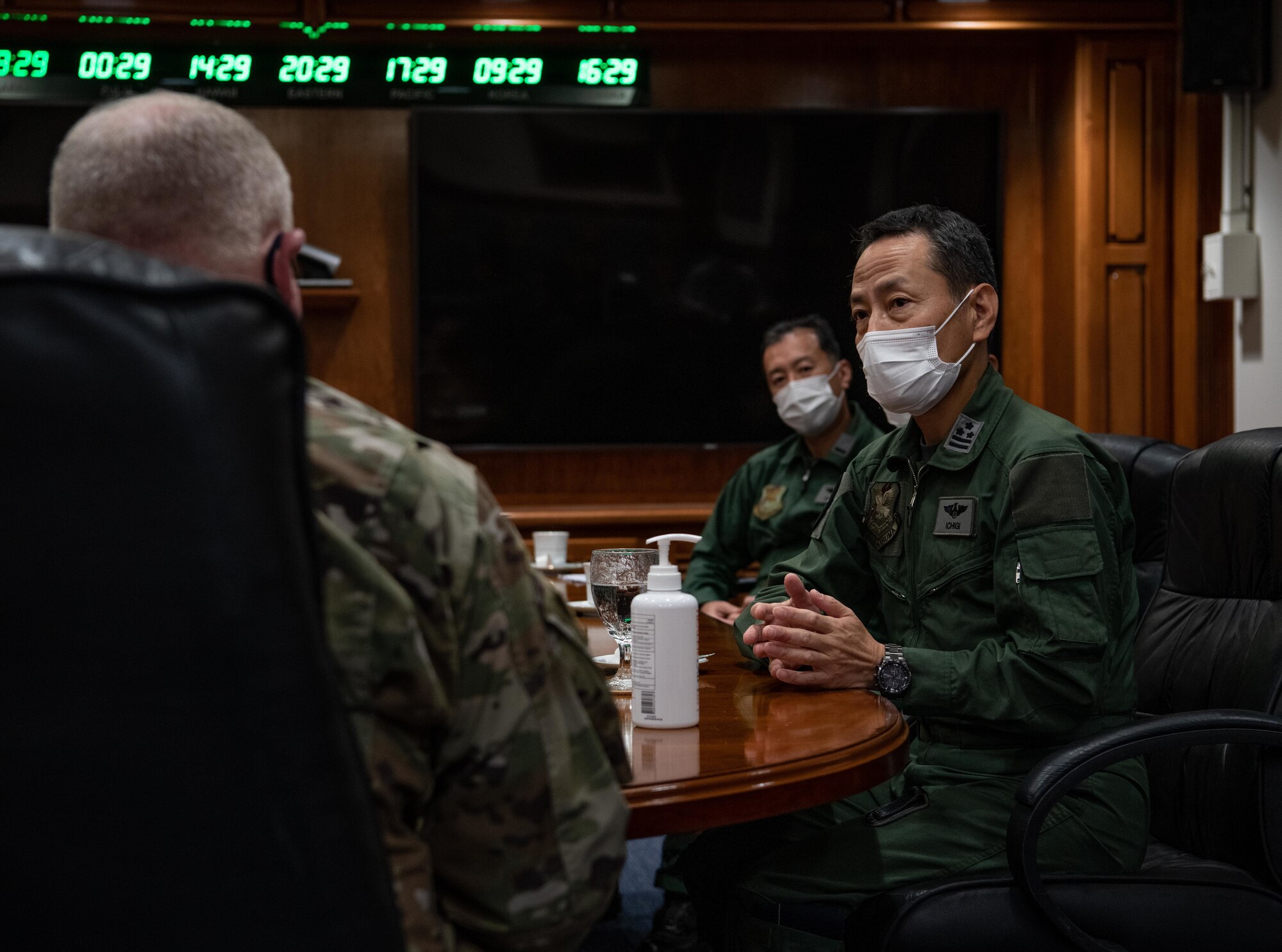 Japan Air Self-Defense Force Col. Hidenori Ichigi, right, 2nd Tactical Airlift Group commander, speaks with U.S. Air Force Col. Ron Schochenmaier, left, 18th Wing vice commander, while JASDF Warrant Officer Nobuyoshi Sasaki, middle, 2nd Tactical Airlift Group senior enlisted leader, observes the meeting at Kadena Air Base, Japan, Oct. 28, 2021. Leaders from both forces met as part of Exercise Southern Beach, a week-long bilateral exercise to strengthen the partnership and enhance interoperability of their two forces. (U.S. Air Force photo by Airman 1st Class Anna Nolte)