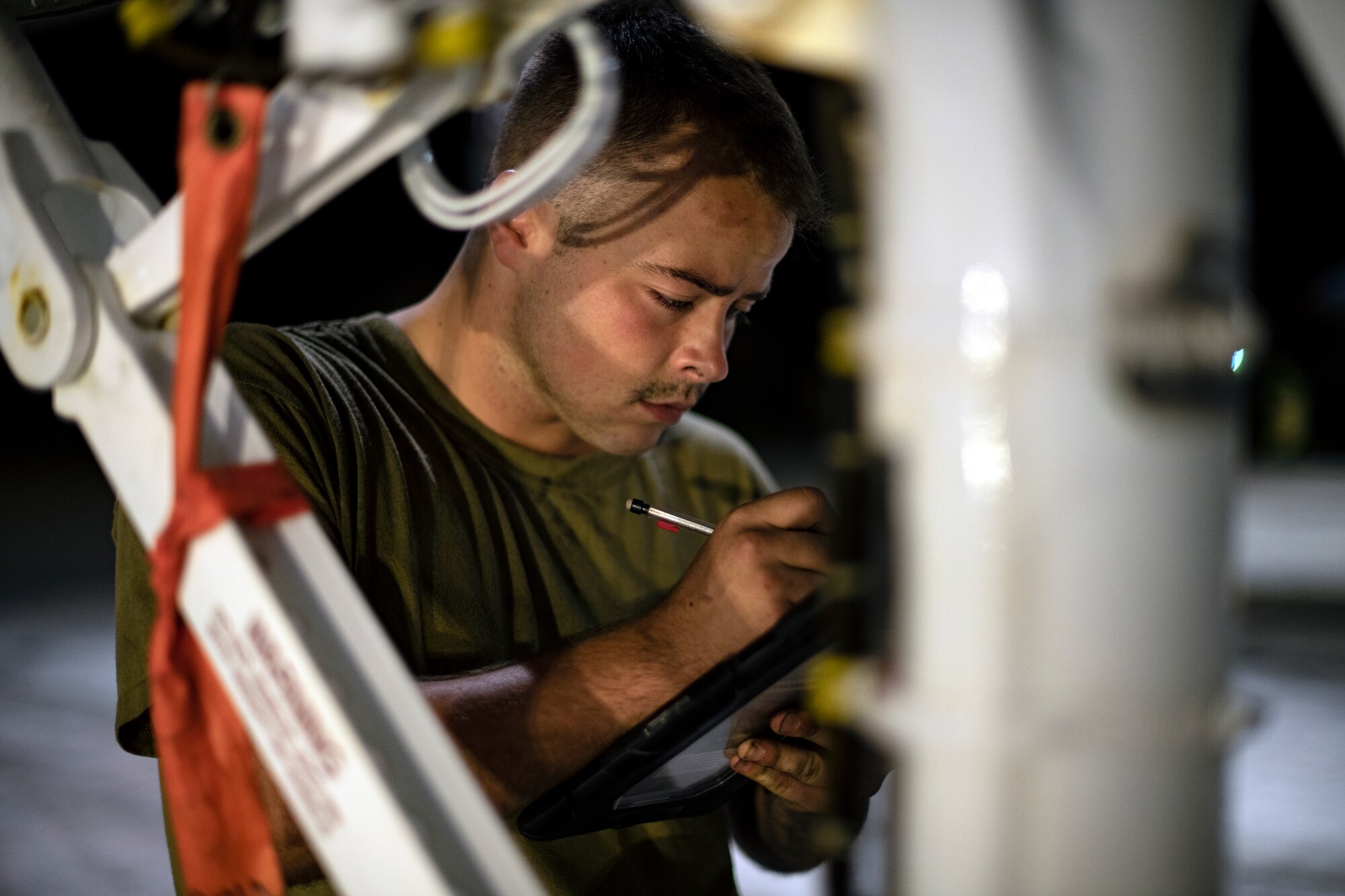 U.S. Air Force Senior Airman Michael Bytell-Lancer, 44th Aircraft Maintenance Unit crew chief, performs post-flight checks on an F-15C Eagle after a training sortie in support of Exercise Southern Beach at Kadena Air Base, Japan, Oct. 28, 2021. This was the first time since the inception of Southern Beach where the majority of the mission sets and a Japan-U.S. training program were conducted during night hours. (U.S. Air Force photo by Senior Airman Jessi Monte)