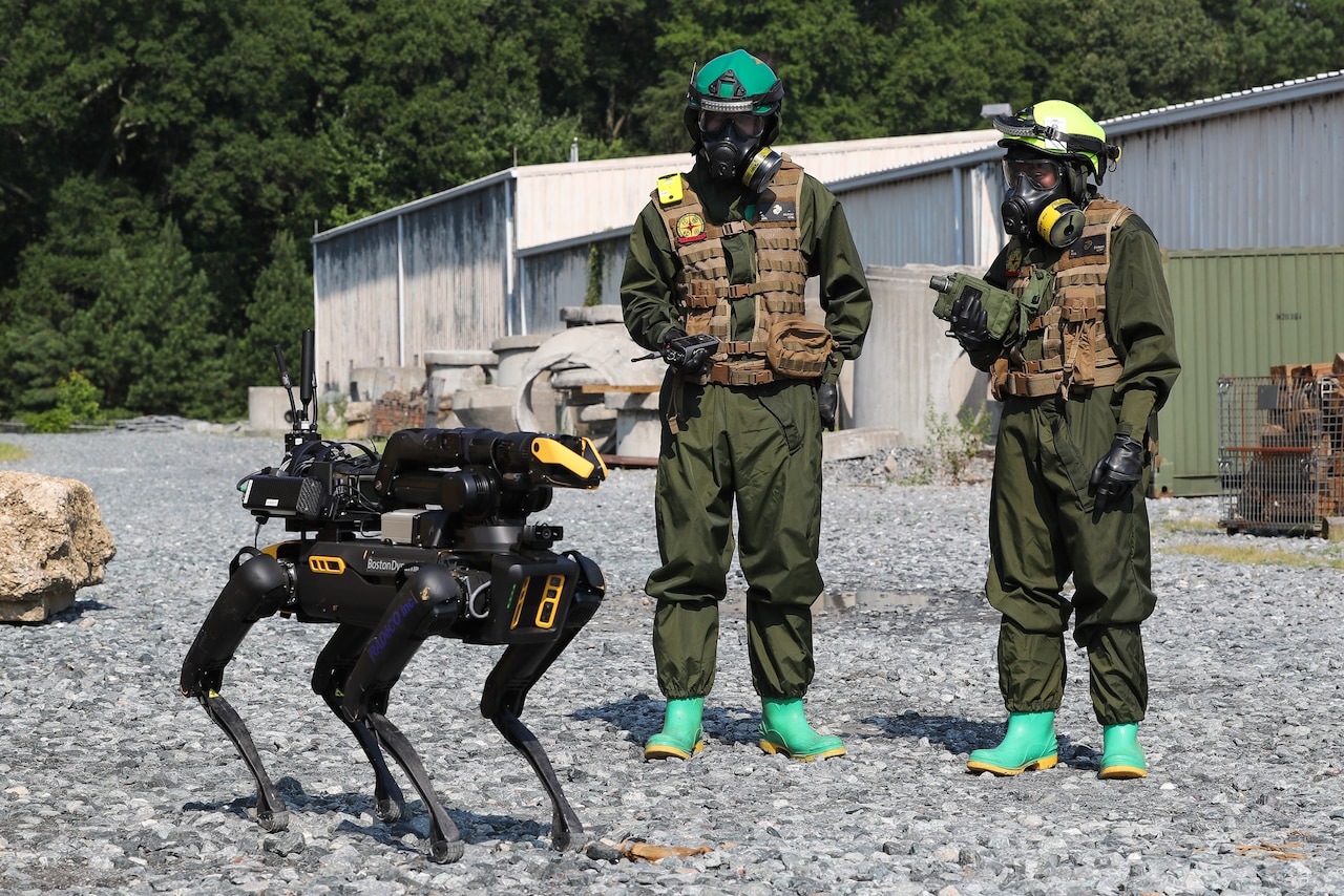 Chemical Biological Incident Response Force (CBIRF) Marines monitor the progress of an unmanned ground vehicle (UGV) "Cerberus" down range as the UGV searches for chemical and radiation hazards during the Technology Experimentation and Characterization Field Trials at the CBIRF Downey Responder Training Facility, July 26-30. The trials were cohosted by Naval Surface Warfare Center Indian Head Division Chemical, Biological and Radiological Defense Division and CBIRF. (U.S. Navy photo by Matthew Poynor)