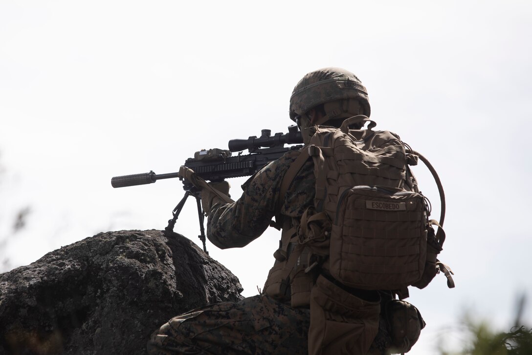 A U.S. Marine with Kilo Co, 3d Battalion, 3d Marines, 3d Marine Division, posts security while conducting the infantry platoon battle course during Bougainville II, Pohakuloa Training Area, Hawaii, Oct. 12, 2021. Bougainville II is part of the battalion’s pre-deployment work-up and is designed to increase combat readiness. (U.S. Marine Corps photo by Cpl. Brandon Aultman)