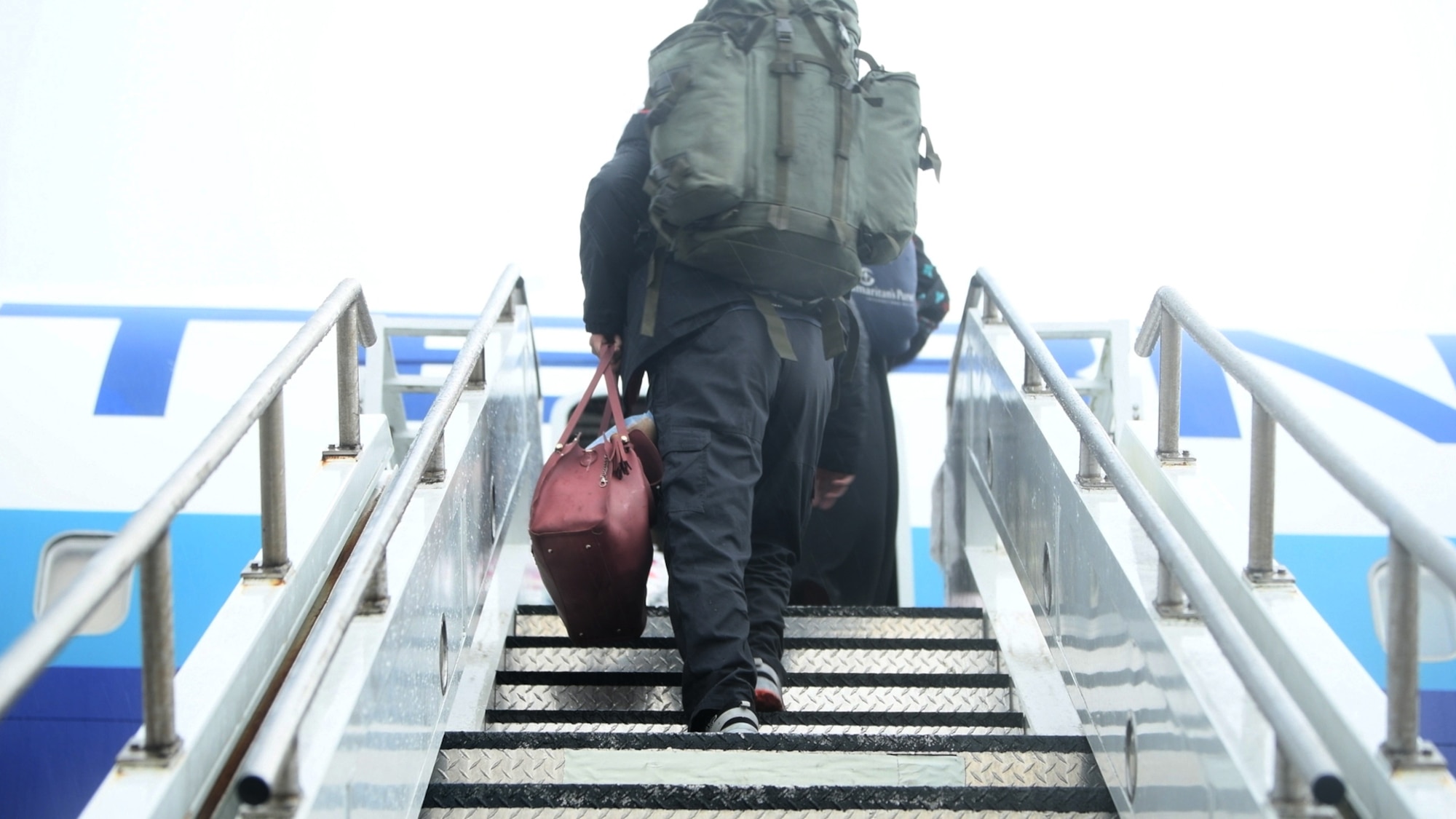 Afghan evacuees board the final flight to the United States from Ramstein Air Base, Germany, Oct. 30, 2021. Most evacuees departed by Oct. 17, but a small number remained at Ramstein after testing positive for COVID-19 during a pre-departure screening. Those patients and their families were placed in isolation until it was safe to travel. (U.S. Air Force photo by Staff Sgt. Philip Bryant)