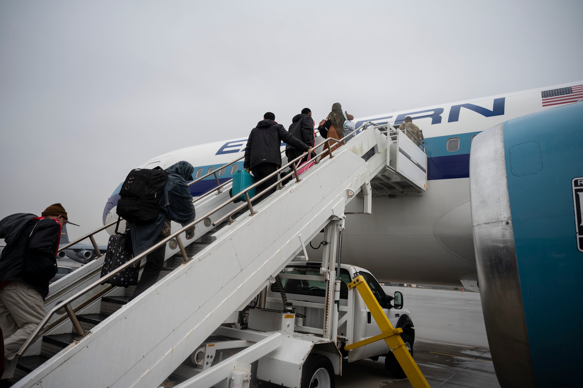 Afghan evacuees board the final outbound flight to the United States from Ramstein Air Base, Germany, Oct. 30, 2021. Ramstein provided evacuees with temporary lodging, food, medical services and support while awaiting transportation to the U.S. and other transient locations after receiving measles, mumps, rubella and COVID-19 vaccinations. (U.S. Air Force photo by Senior Airman Milton Hamilton)