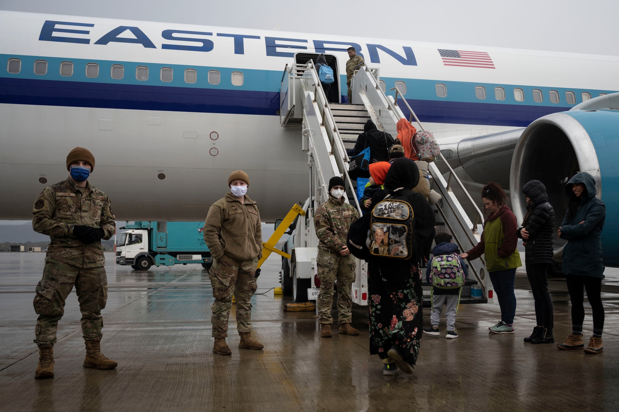 Afghan evacuees board the final flight to the United States from Ramstein Air Base, Germany, Oct. 30, 2021. Most evacuees departed by Oct. 17, but a small number remained at Ramstein after testing positive for COVID-19 during a pre-departure screening. Those patients and their families were placed in isolation until it was safe to travel. (U.S. Air Force photo by Senior Airman Milton Hamilton)
