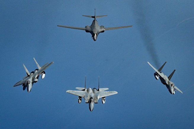 Royal Saudi Air Force F-15 Strike Eagles break away from a formation with a U.S. Air Force B-1B Lancer over the Red Sea as part of a presence patrol above the U.S. Central Command’s area of responsibility Oct. 30, 2021. This mission is the fifth of its kind in 2021 and successfully demonstrates the strength of U.S. security relationships and capabilities in the region. (U.S. Air Force photo by Senior Airman Jerreht Harris)