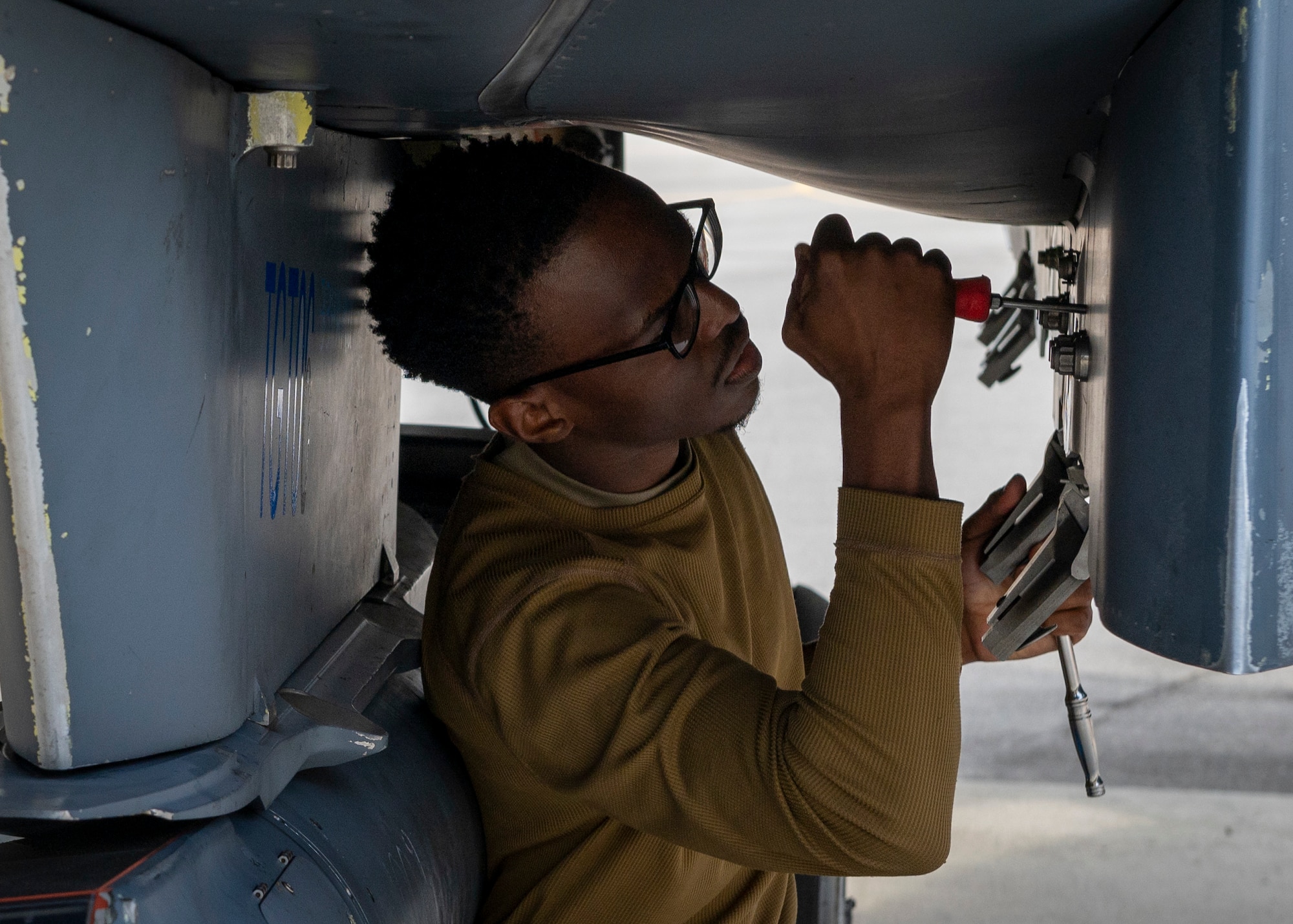 A load crew member prepares a bomb rack unit 47 by setting the pitch valve settings on a bomb rack prior to loading the GBU-38 during a quarterly load crew competition at Seymour Johnson Air Force Base, North Carolina, Oct. 21, 2021.