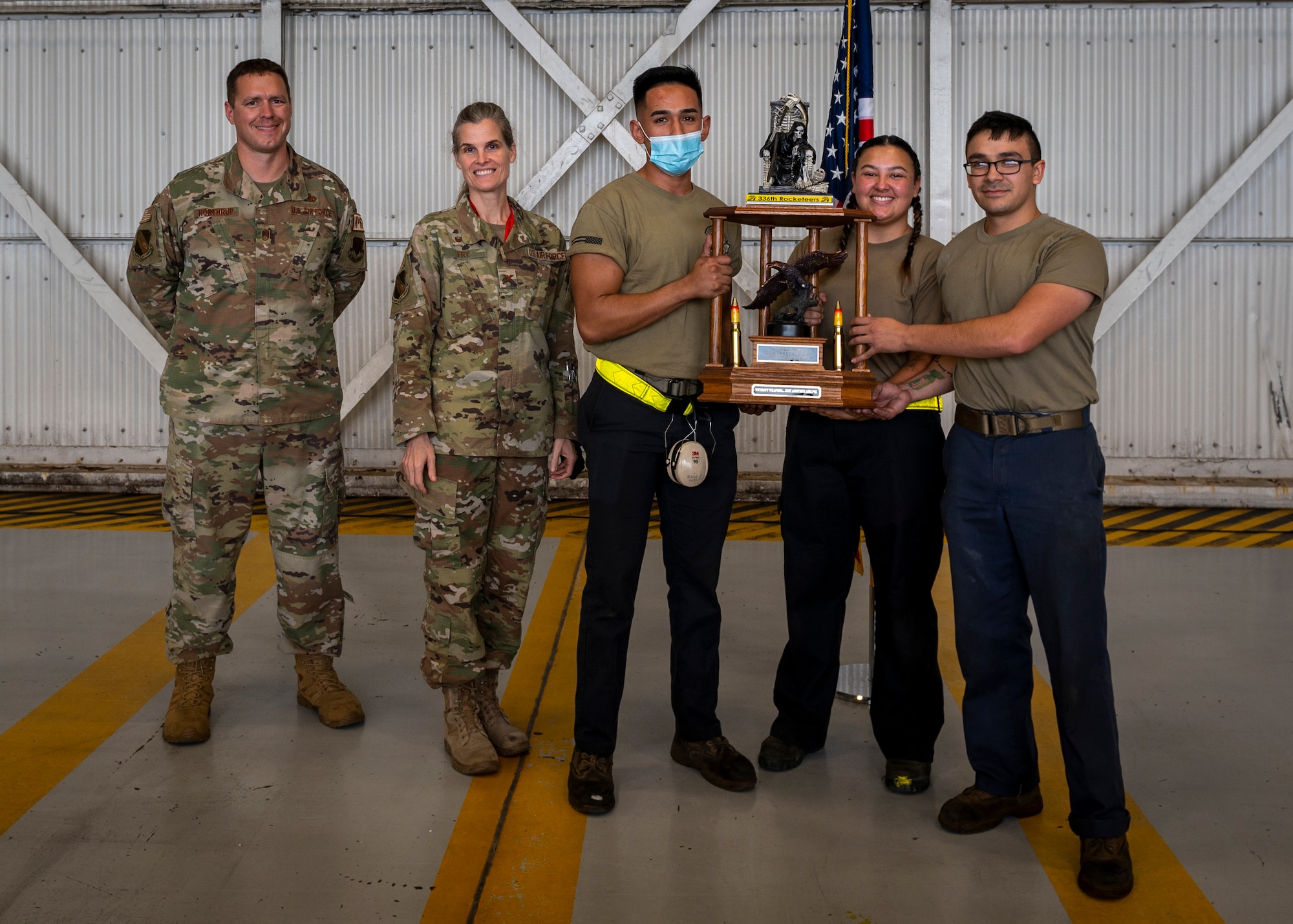 Col. Leah Fry, 4th Maintenance Group commander and Chief Richard Northrup, 4th MXG wing weapons manager, present the load crew of the quarter trophy to the winners at Seymour Johnson Air Force Base, North Carolina, Oct. 21, 2021.