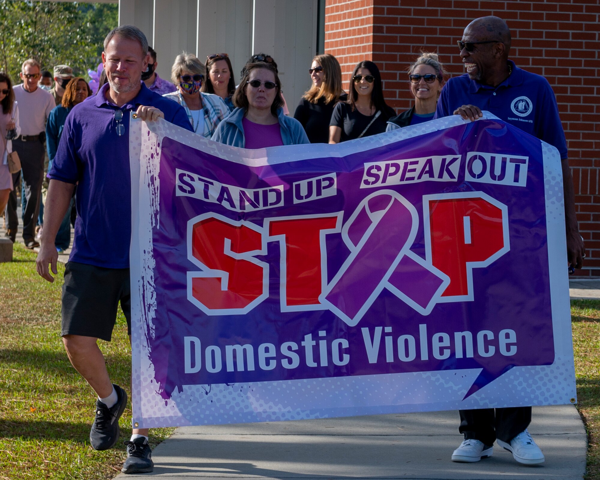 Members of Team Seymour participate in a Walk in my Shoes event to raise domestic violence awareness at Seymour Johnson Air Force Base, North Carolina, Oct. 21, 2021.